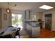 Bright kitchen with blue and white cabinets, stainless steel appliances, and sliding door to the deck at 308 Baron Ave, Lafayette, CO 80026