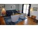 Inviting living room with hardwood floors, comfortable seating, and natural light from the window at 308 Baron Ave, Lafayette, CO 80026