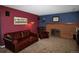 Cozy living room features a brick fireplace, comfortable leather seating, and decorative lighting at 308 Baron Ave, Lafayette, CO 80026