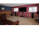 Open living room features a brick fireplace, a flat screen TV, and shelves at 308 Baron Ave, Lafayette, CO 80026