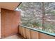 Outdoor balcony with red brick and view of a large tree at 5120 Williams Fork Trl # 210, Boulder, CO 80301