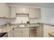 A kitchen with stainless steel appliances, granite countertops, light gray cabinets, and breakfast bar at 5120 Williams Fork Trl # 210, Boulder, CO 80301