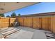 Fenced back patio with concrete floor, striped rug, and an air conditioning unit at 13003 W 20Th Ave, Golden, CO 80401