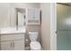 Well-lit bathroom with modern vanity, overhead storage, and glass shower door at 13003 W 20Th Ave, Golden, CO 80401