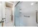 This bathroom features a sliding glass door shower, grab bars, and white marbled floors at 13003 W 20Th Ave, Golden, CO 80401