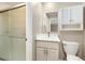 This bathroom features a single sink vanity with white cabinets and a glass-enclosed shower at 13003 W 20Th Ave, Golden, CO 80401