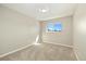 Minimalist bedroom with neutral paint, carpet, and a bright window at 13003 W 20Th Ave, Golden, CO 80401