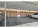 Carport with parking, metal supports, a wood fence, and access to the property at 13003 W 20Th Ave, Golden, CO 80401