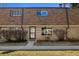 Two-story brick townhome with brown roof, tidy landscaping, and a sidewalk to the entrance at 13003 W 20Th Ave, Golden, CO 80401
