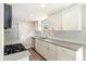 Bright kitchen with white cabinets, stainless steel appliances, and a modern backsplash at 13003 W 20Th Ave, Golden, CO 80401