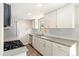 Bright kitchen with stainless steel appliances, white cabinets, and a window over the sink at 13003 W 20Th Ave, Golden, CO 80401