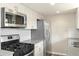 Stylish kitchen with stainless steel appliances, and gray countertops at 13003 W 20Th Ave, Golden, CO 80401