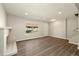 Well-lit living room with wood floors and a brick fireplace at 13003 W 20Th Ave, Golden, CO 80401