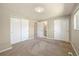A main bedroom with neutral walls includes sliding closet doors and an ensuite bathroom at 13003 W 20Th Ave, Golden, CO 80401
