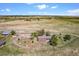 Aerial view of property showing home, outbuildings, and surrounding pasture at 40121 County Road 21, Elizabeth, CO 80107