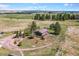 Stunning aerial view of a home and property featuring mature trees, a circular driveway and a peaceful, rural setting at 40121 County Road 21, Elizabeth, CO 80107