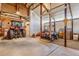 Barn interior with concrete flooring housing a tractor, 4-wheeler and other equipment for property maintenance at 40121 County Road 21, Elizabeth, CO 80107