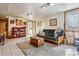 Bright basement living room features tiled floors, a carpeted rug, recessed lighting, and a seating area at 40121 County Road 21, Elizabeth, CO 80107