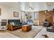 Cozy basement with fireplace, exposed brick, carpeted rug, recessed lighting, and lots of living space at 40121 County Road 21, Elizabeth, CO 80107