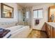 Bright bathroom featuring tub, glass shower, wood cabinets, and tiled floors, creating a comfortable, stylish space at 40121 County Road 21, Elizabeth, CO 80107