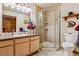 Well-lit bathroom features a sink, a shower, and tiled floors, creating a relaxing and inviting atmosphere at 40121 County Road 21, Elizabeth, CO 80107