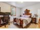 Bright bedroom with a desk, carpeted floors, a window, a wooden bed frame, and warm, natural light at 40121 County Road 21, Elizabeth, CO 80107