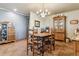 A traditional dining room featuring a wooden table set, vintage cabinets, and charming decor at 40121 County Road 21, Elizabeth, CO 80107