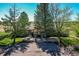 An inviting one story home featuring a stone patio, trees, and well-maintained landscaping at 40121 County Road 21, Elizabeth, CO 80107
