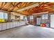 Large garage interior with workbench area, overhead lighting, and storage at 40121 County Road 21, Elizabeth, CO 80107
