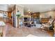 Open concept living room with tile flooring, stainless steel appliances, and cozy stone fireplace at 40121 County Road 21, Elizabeth, CO 80107