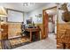 Office room featuring wood paneling, a rug, natural light, an external door, and tiled floors at 40121 County Road 21, Elizabeth, CO 80107