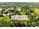 Aerial view of community tennis courts surrounded by lush green trees at 8571 Gold Peak Dr # F, Highlands Ranch, CO 80130