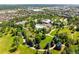 Aerial view of clubhouse, pool, pond, and green common areas in neighborhood at 8571 Gold Peak Dr # F, Highlands Ranch, CO 80130