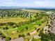 Aerial view of a golf course community with lush green fairways and mountain views at 8571 Gold Peak Dr # F, Highlands Ranch, CO 80130