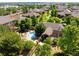 An aerial view of a home and neighborhood with lush green trees and a pool at 8571 Gold Peak Dr # F, Highlands Ranch, CO 80130