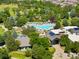 Aerial view of community clubhouse and pool surrounded by lush greenery at 8571 Gold Peak Dr # F, Highlands Ranch, CO 80130