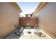 Cozy back patio featuring pavers, wood fence, bistro table, and 2 rocking chairs at 8571 Gold Peak Dr # F, Highlands Ranch, CO 80130