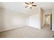 Bedroom with neutral carpet, light walls, ceiling fan, and double door closet at 8571 Gold Peak Dr # F, Highlands Ranch, CO 80130