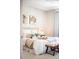 Comfortable bedroom with white bedding, end tables, decorative pillows, and modern art at 8571 Gold Peak Dr # F, Highlands Ranch, CO 80130
