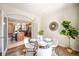 The Dining room features a glass table, four white chairs, a view into the kitchen and outdoor access at 8571 Gold Peak Dr # F, Highlands Ranch, CO 80130