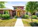 Inviting two-story home features a stone entrance, colorful facade, and well-maintained landscaping at 8571 Gold Peak Dr # F, Highlands Ranch, CO 80130