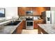 Well-appointed kitchen featuring wooden cabinetry, stainless steel appliances, and granite countertops at 8571 Gold Peak Dr # F, Highlands Ranch, CO 80130