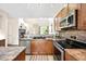 Modern kitchen showcasing stainless steel appliances, and a view of the living space at 8571 Gold Peak Dr # F, Highlands Ranch, CO 80130