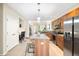 Modern kitchen with a central island, stainless appliances, and a dedicated office space at 8571 Gold Peak Dr # F, Highlands Ranch, CO 80130