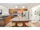 A kitchen with wood cabinets, stone countertops, stainless steel appliances and a center island with seating at 8571 Gold Peak Dr # F, Highlands Ranch, CO 80130