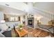 Bright living area with a stone fireplace, hardwood floors, and staircase at 8571 Gold Peak Dr # F, Highlands Ranch, CO 80130