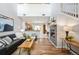 Open-concept living room featuring a fireplace, hardwood floors, and contemporary decor at 8571 Gold Peak Dr # F, Highlands Ranch, CO 80130