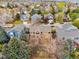 Aerial view of a residential neighborhood showcasing homes with manicured lawns and mature trees at 8766 Cresthill Ln, Highlands Ranch, CO 80130