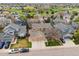 Aerial view of a residential neighborhood showcasing homes with well-maintained lawns, mature trees and a golf course at 8766 Cresthill Ln, Highlands Ranch, CO 80130