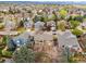 Aerial view of a residential neighborhood showcasing well-maintained homes and mature trees at 8766 Cresthill Ln, Highlands Ranch, CO 80130